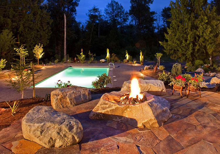 Landscaping articles Bellevue Seattle - feature showing pool with stone landscaping and lighting.