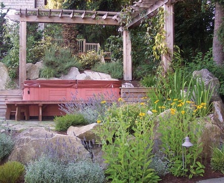 Arbor surrounds hot tub and supports plants that offer privacy