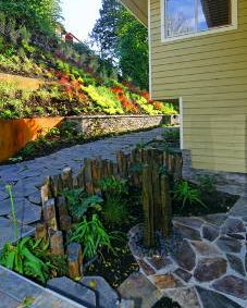 Rock fountain and colorful hillside add elegance to Mercer Island home.