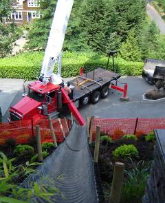 Backyard landscaping in Mercer Island requires heavy machinery to move top soil.