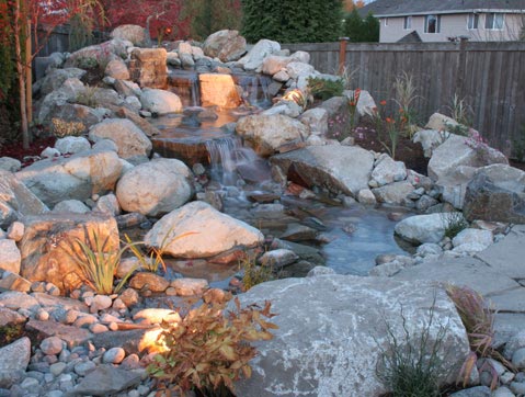 Waterfall over river rock and stone rock designed by Environmental Construction Inc. in Kirkland WA